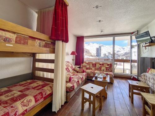 - une chambre d'hôtel avec des lits superposés et un canapé dans l'établissement Studio lumineux, ski aux pieds, balcon sud, 24 m², 4 pers, 2 flocons argent - La Croisette, Les Belleville - FR-1-344-1180, aux Menuires