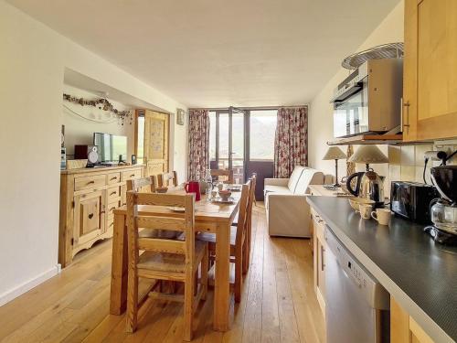 une cuisine avec une table et des chaises dans une pièce dans l'établissement Appartement ensoleillé, 2 pièces cabine, balcon sud, pour 6 pers., centre station, près des pistes - FR-1-344-1178, aux Menuires