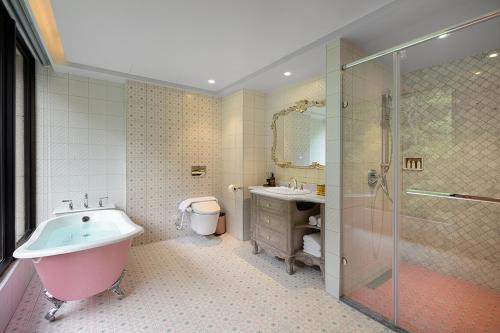 a bathroom with a tub and a sink and a shower at 格拉斯行館 Grasse Grace Manor 苗栗唯一SLH會員 in Nanzhuang