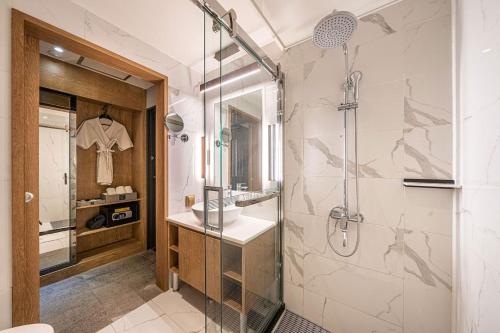a bathroom with a shower and a sink at Hotel Ritz in Suwon
