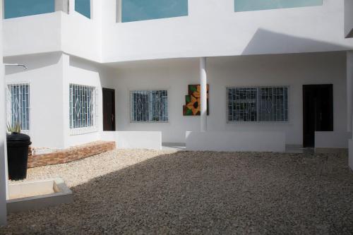 a large room with white walls and windows at CASAS BLANCAS Coveñas in Coveñas