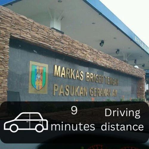 a sign on the side of a building with a car on it at Seeds Hotel Cheras Taman Bukit Segar in Cheras