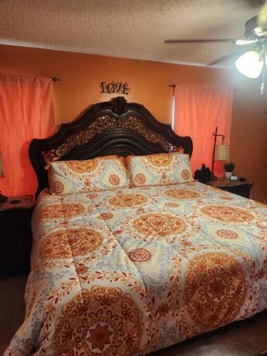 a bedroom with a large bed with orange walls at Beautiful home near mall & beach in St. Petersburg