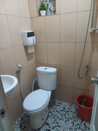 a bathroom with a toilet and a sink at joglo house karinduaji madasari in Bulakbenda