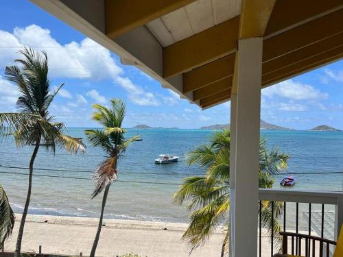a view of a beach with a boat in the water at Bahari in Carriacou