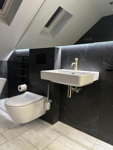 a bathroom with a sink and a toilet at Laurieston Penthouse 
