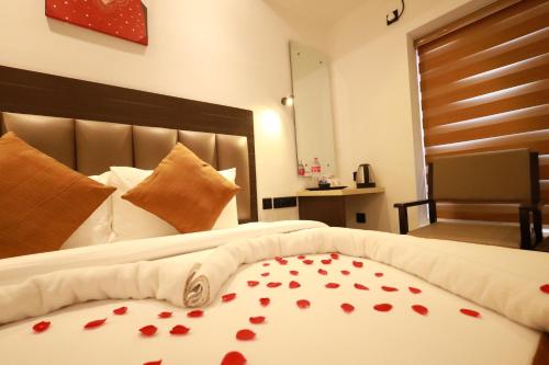 a bedroom with a bed with red hearts on it at Goodland Elegance in Trivandrum