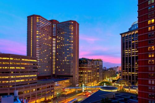 a city skyline with tall buildings at night at Boston Marriott Copley Place in Boston
