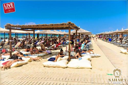 a group of people laying on the beach at Vasiliki's Apartment in Nea Kalikratia