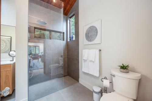 a bathroom with a shower and a toilet and a sink at Secluded Forest Oasis - Your Ultimate Retreat Awaits! in Montara