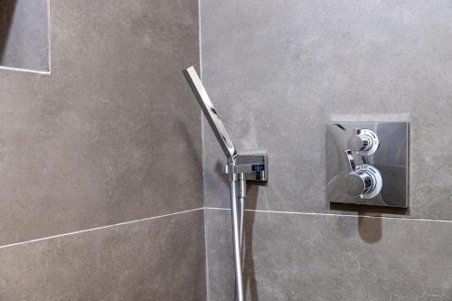 a shower in a bathroom with a shower nozzle at Secluded Forest Oasis - Your Ultimate Retreat Awaits! in Montara