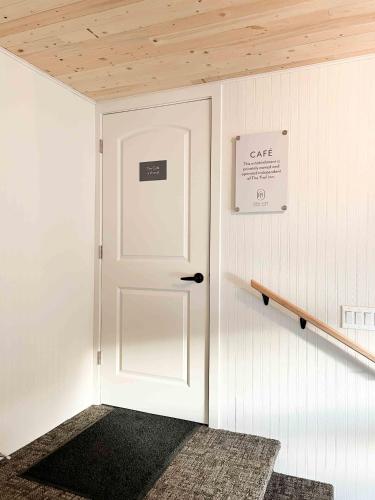 a white door in a room with a sign on it at The Trail Inn - Melita, Manitoba - HWY 83, HWY 3 in Melita