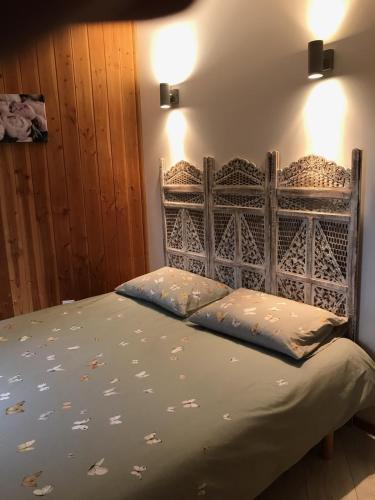 un lit avec deux oreillers dessus dans une chambre dans l'établissement Chalet dans plusieurs hectares de nature, à Barjols