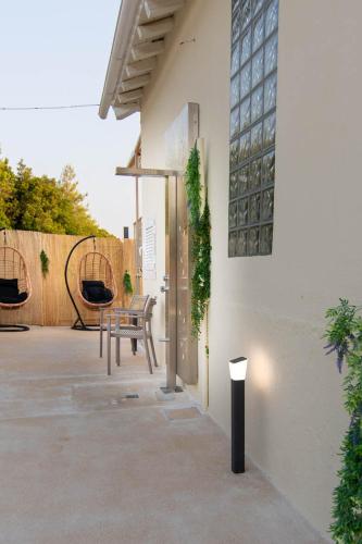 a bench sitting on a patio next to a building at Villa George in Skiathos in Skiathos Town