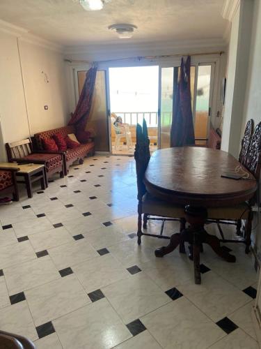a living room with a table and a couch at abo talat in El-Shaikh Mabrouk