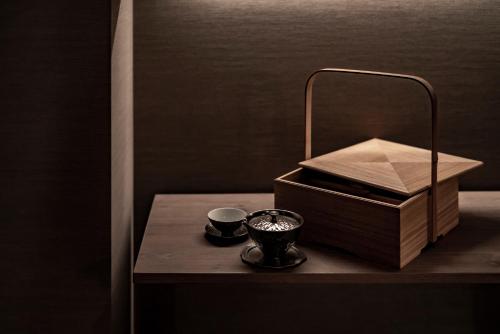 a table with a box and a cup on it at THE HOTEL HIGASHIYAMA KYOTO TOKYU, A Pan Pacific Hotel in Kyoto
