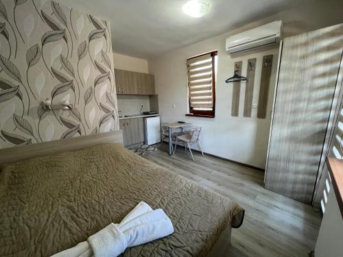 a small bedroom with a bed and a kitchen at House Varna-1 in Krapets