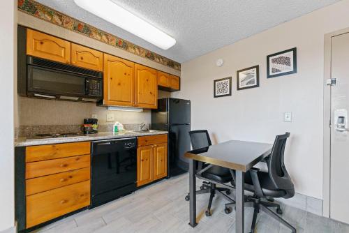 a kitchen with a table and a black refrigerator at Metro Scottsdale Apartments 1 bd 1 ba PREMIUM in Scottsdale