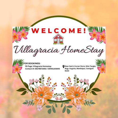 een welkomstkaart met een bloemenkrans bij Villagracia HomeStay 