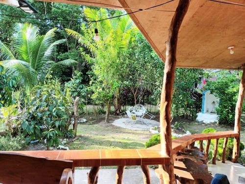 a view of a garden from a porch with a bench at Villagracia HomeStay 