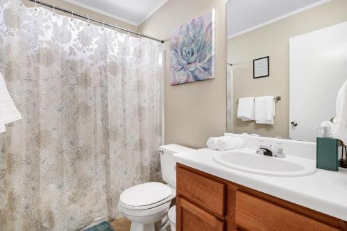 a bathroom with a toilet and a sink and a shower at Seaworld Retreat Unwind Just Steps From The Action in San Antonio