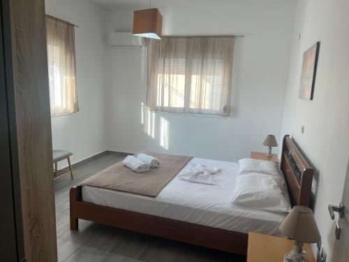 a bedroom with a bed with two towels on it at Village Dream-Rhodes Airport in Paradeísion