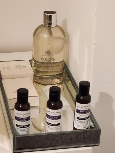 three bottles of medicine in a tray in a refrigerator at Private luxurious space in Basildon