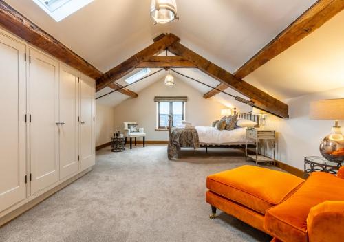 a living room with a vaulted ceiling and a bedroom at Camlad Barn in Chirbury