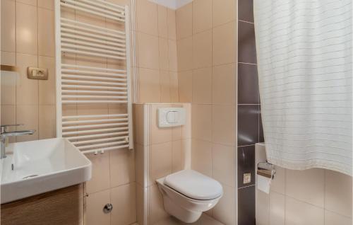 a small bathroom with a toilet and a sink at Gorgeous Home In Rab With House Sea View in Rab