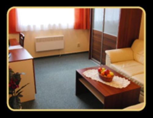 a living room with a couch and a table at Rekreačné zariadenie Crocus in Vysoké Tatry