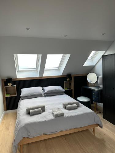 a bedroom with a bed with two towels on it at Laurieston Penthouse 