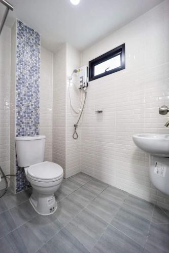 a bathroom with a toilet and a sink at Gasira Green in Ban Tha Kham