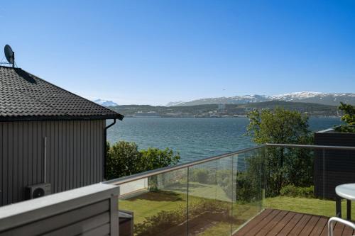 a balcony with a view of the water at Seaview studio w/terrace&parking in Tromsø