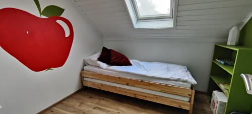 a room with a bed with an apple on the wall at Beautiful apartment in the heart of Reykjavik in Reykjavík