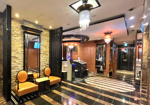 a lobby with chairs and a desk in a building at APA Hotel Kanda Jimbocho Ekihigashi in Tokyo