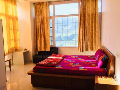 a bedroom with a bed and a large window at The Bagain in Shimla