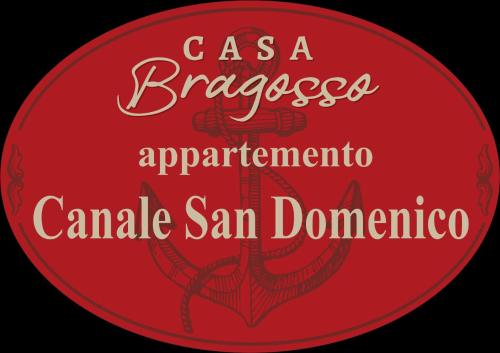 a red sign with the words casa braggaggosaarmaarma camel san at Casa bragosso in Sottomarina