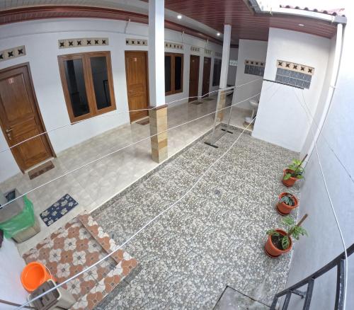 an overhead view of a house with a floor at Griyo Mondoliko Homestay Jogja in Demangan