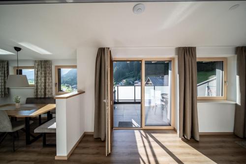 a living room with a table and a dining room at Appartements Tyrol in Pettneu am Arlberg