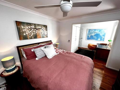 a bedroom with a large bed and a ceiling fan at The Treehouse at Copa in Copacabana