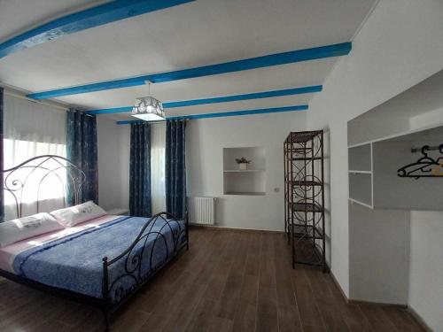 a bedroom with a bed with a blue ceiling at Guest house of gnomes in Akhmety