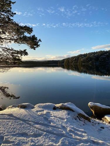 a view of a lake with snow on the ground at Perfect for country lovers in Grantown on Spey