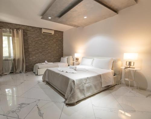 a bedroom with a large bed with white pillows at Villa Vitti's - Verona est in San Martino Buon Albergo