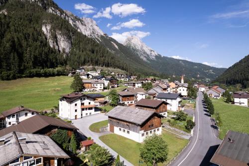 a small village in the mountains with a road at Appartements Tyrol in Pettneu am Arlberg