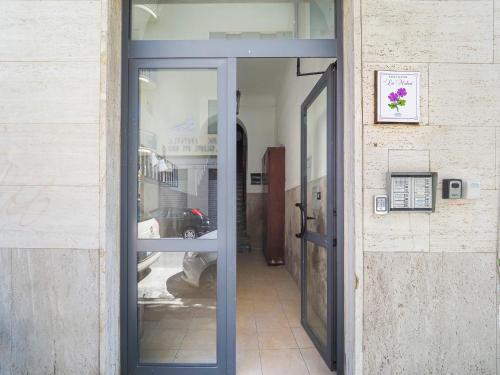 un ingresso a un edificio con porta a vetri di La Malva - L'Opera Group a La Spezia