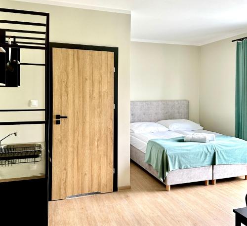 a bedroom with a bed and a sliding door at Aruka in Władysławowo