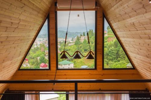 a large window in a room with wooden ceilings at Panorama BatumGora in Batumi