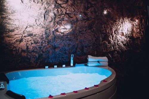 a bath room with a tub in a cave at Love Cottage 2 mit Whirlpool in Hagen