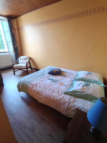 a dog laying on a bed in a bedroom at Gîte des Pierres Dorées in Saint-Germain-Nuelles