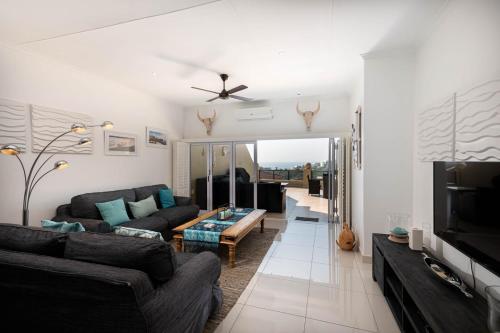 a living room with a couch and a tv at Bayridge 48 ~ Penthouse in Ballito